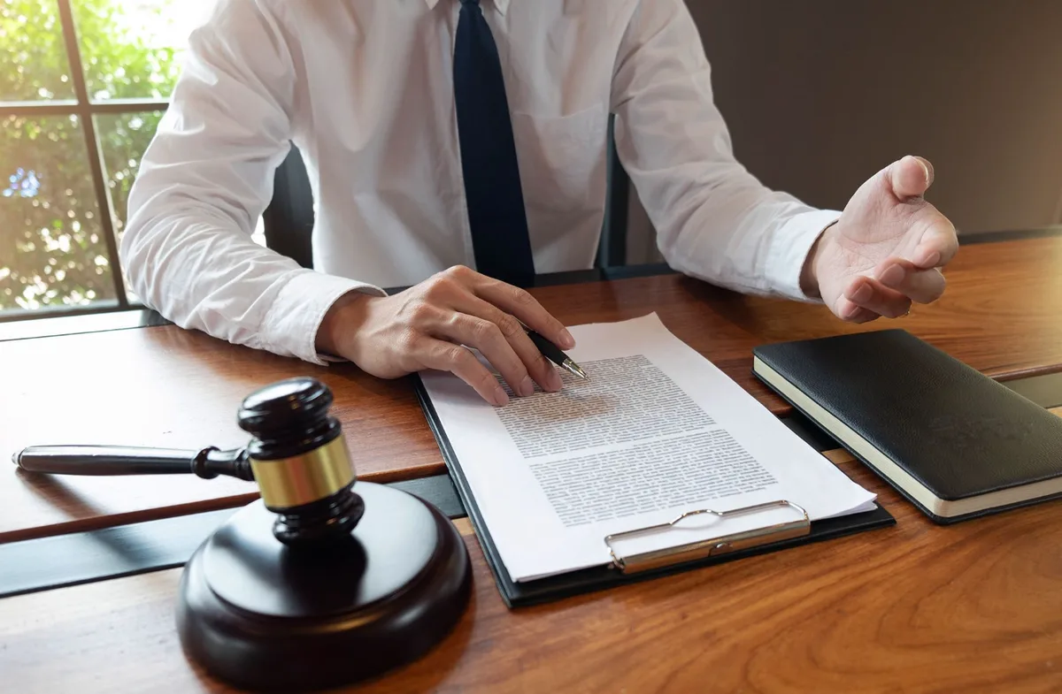 Attorney walking a client through filing paperwork at the desk