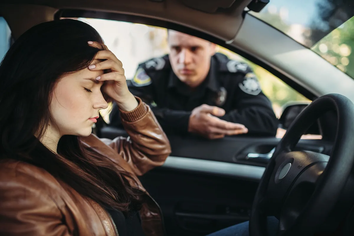 Driver speaking with a police officer during a traffic stop